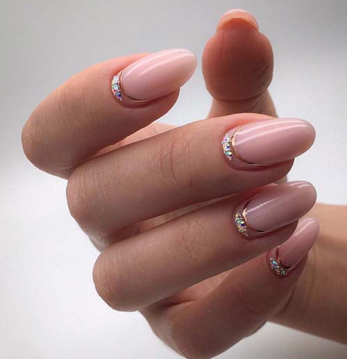 Ροζ half moon nails με στρας και χρυσή γραμμή