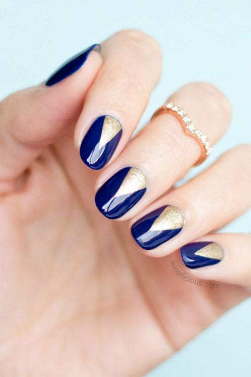 Μπλε σκούρα νύχια με τριγωνικό χρυσό ανάποδο γαλλικό